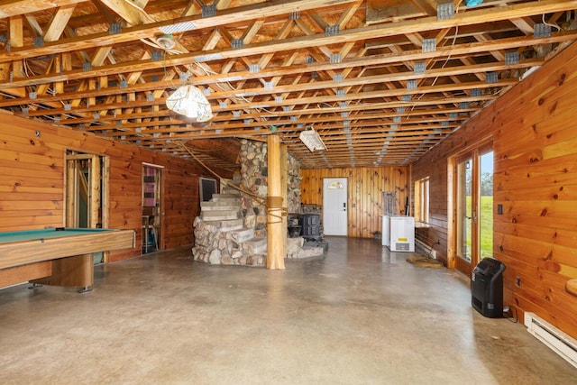 11840 Schreiner Rd, Bellevue, MI 49021 - basement featuring a wood stove, wood walls, a baseboard radiator, and pool table