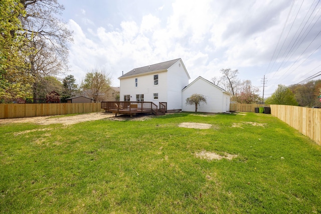 back of house featuring a fenced backyard, a deck, and a yard