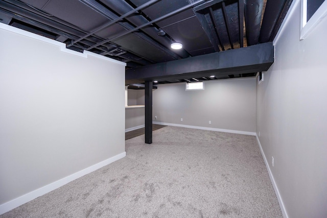 basement featuring baseboards and carpet