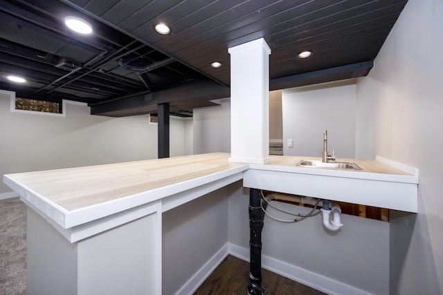 interior space with recessed lighting, dark wood finished floors, baseboards, and a sink
