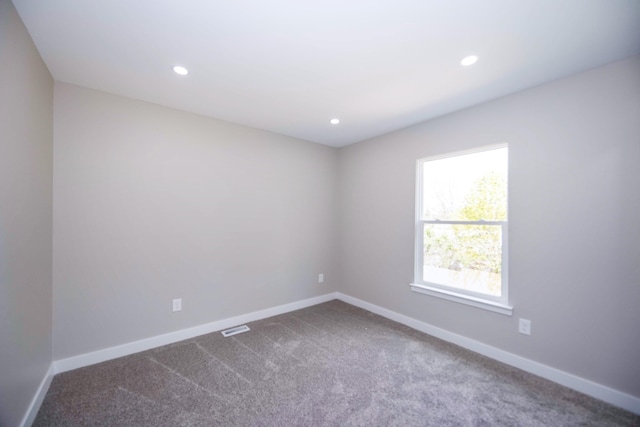 unfurnished room featuring baseboards, dark colored carpet, and recessed lighting