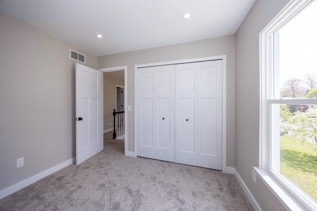 unfurnished bedroom featuring carpet, visible vents, and recessed lighting
