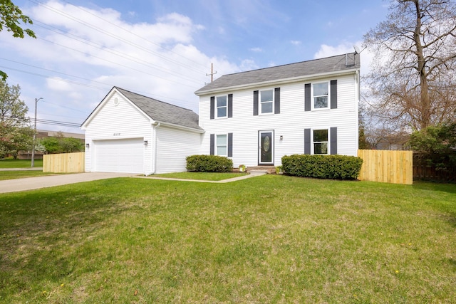colonial house featuring fence, concrete driveway, and a front yard