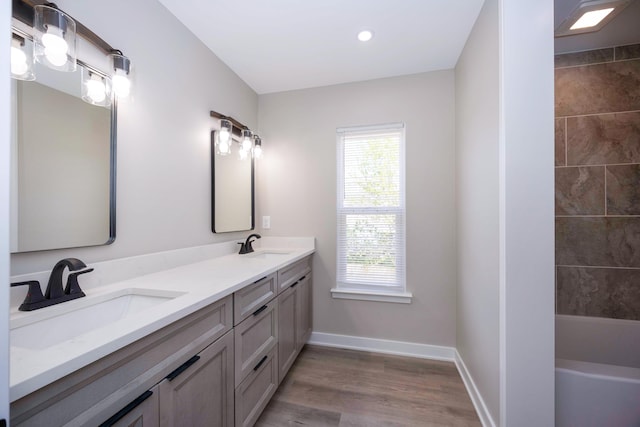 bathroom with a sink, plenty of natural light, and wood finished floors