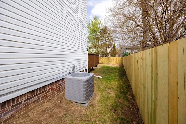 view of home's exterior with cooling unit and a fenced backyard
