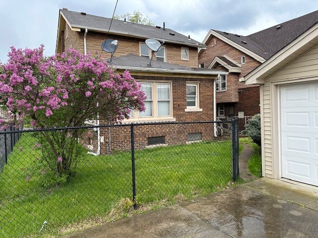view of home's exterior featuring a garage, driveway, and brick siding