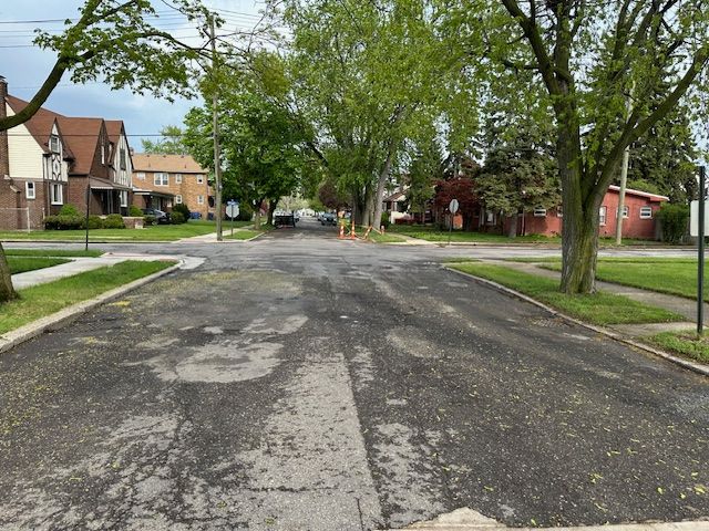 view of road featuring a residential view, curbs, and sidewalks