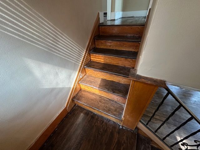 staircase with wood finished floors