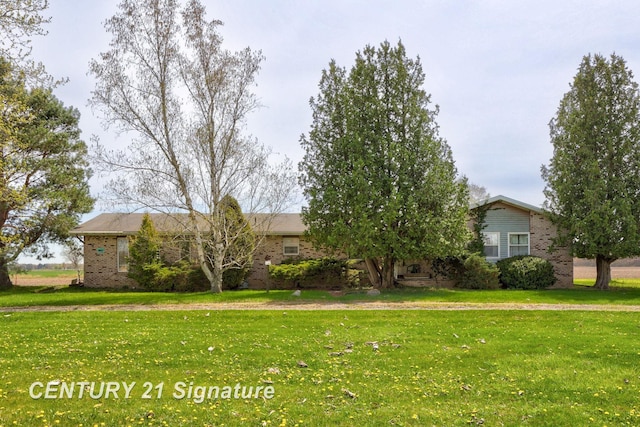view of front of property with brick siding and a front yard