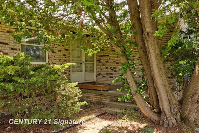 property entrance with brick siding
