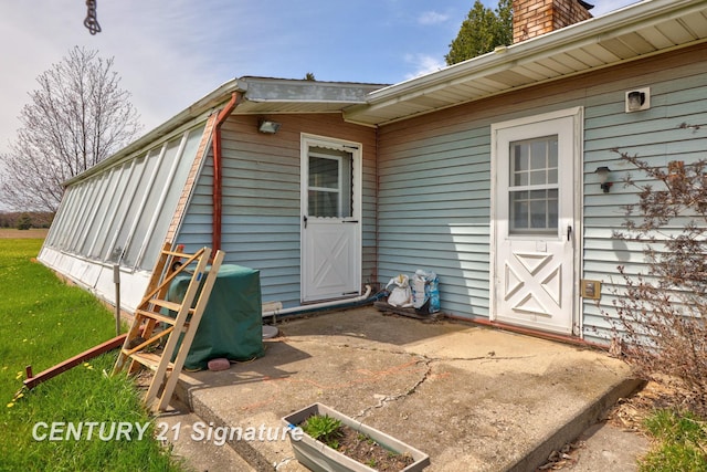 doorway to property with a chimney