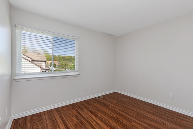 empty room with wood finished floors and baseboards