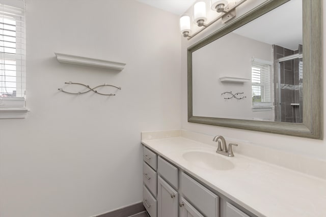 bathroom with vanity and tiled shower