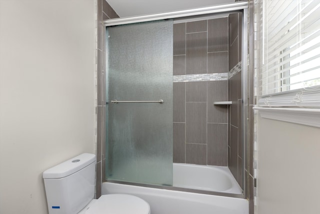 bathroom featuring toilet and enclosed tub / shower combo