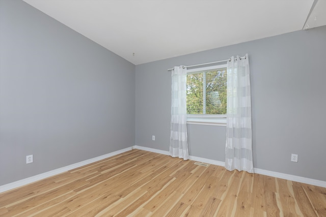 unfurnished room with wood finished floors and baseboards