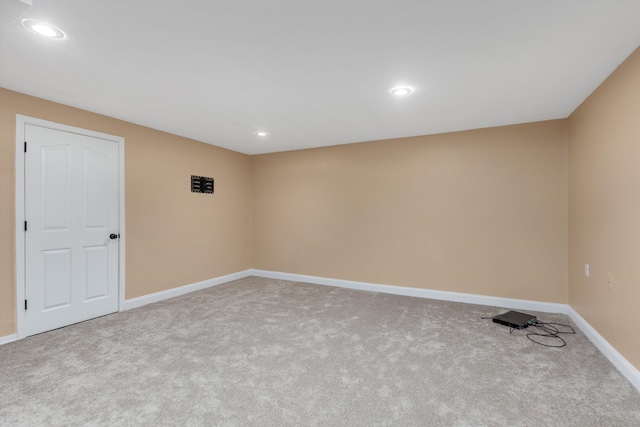 carpeted spare room featuring recessed lighting and baseboards
