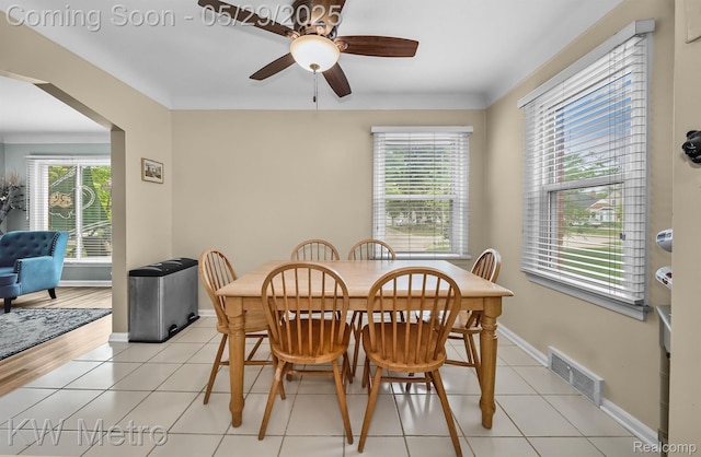 1930 N Wilson Ave, Royal Oak, MI 48073 - dining space featuring ceiling fan, baseboards, light tile patterned floors, and arched walkways
