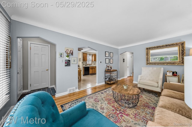 1930 N Wilson Ave, Royal Oak, MI 48073 - living area featuring arched walkways, wood finished floors, and baseboards