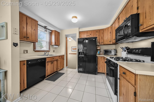 1930 N Wilson Ave, Royal Oak, MI 48073 - kitchen featuring black appliances, light countertops, a sink, brown cabinetry, and light tile patterned floors