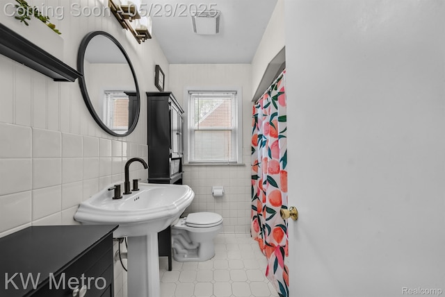 1930 N Wilson Ave, Royal Oak, MI 48073 - bathroom with tile walls, toilet, tile patterned floors, and curtained shower