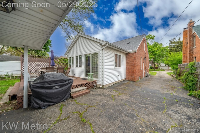 1930 N Wilson Ave, Royal Oak, MI 48073 - view of side of property featuring a deck, brick siding, and roof with shingles