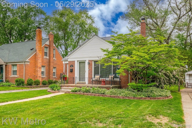 1930 N Wilson Ave, Royal Oak, MI 48073 - view of front facade featuring a front yard, brick siding, and a chimney