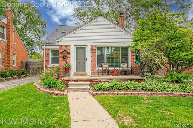 1930 N Wilson Ave, Royal Oak, MI 48073 - bungalow featuring brick siding, covered porch, a chimney, and roof with shingles