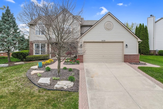 2435 Ivy Hill Dr, Commerce Twp, MI 48382 - traditional-style house featuring a garage, a front lawn, brick siding, and driveway