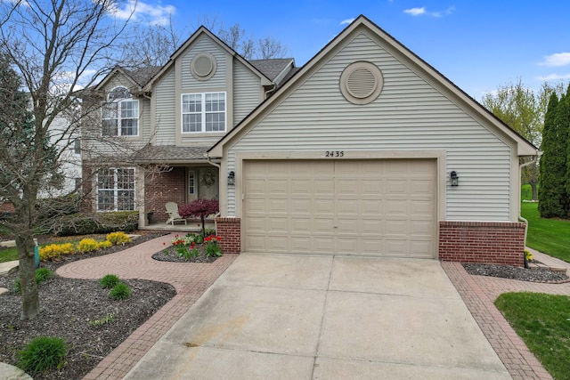 2435 Ivy Hill Dr, Commerce Twp, MI 48382 - traditional home featuring roof with shingles, concrete driveway, a garage, and brick siding