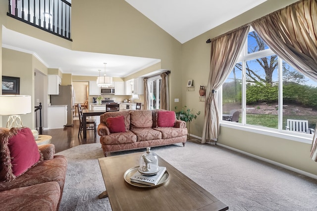 2435 Ivy Hill Dr, Commerce Twp, MI 48382 - living room featuring a wealth of natural light, baseboards, dark carpet, and high vaulted ceiling