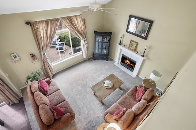 2435 Ivy Hill Dr, Commerce Twp, MI 48382 - carpeted living area with ceiling fan, a warm lit fireplace, and baseboards
