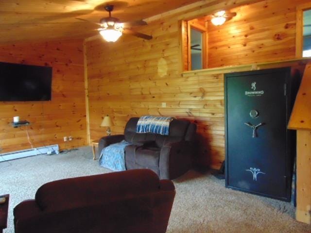 living room with carpet floors, a ceiling fan, and wood walls