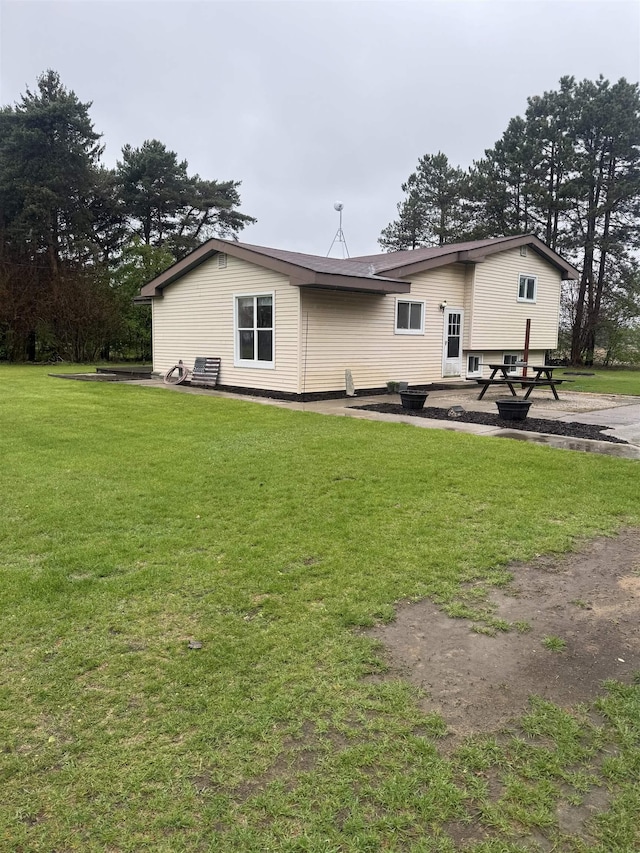 rear view of property with a lawn