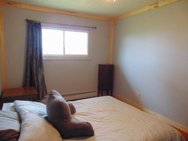 bedroom with baseboard heating and baseboards