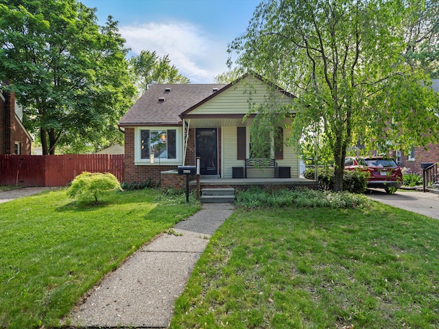 bungalow-style house featuring covered porch, brick siding, and a shingled roof