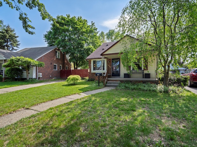 bungalow-style home featuring brick siding and covered porch