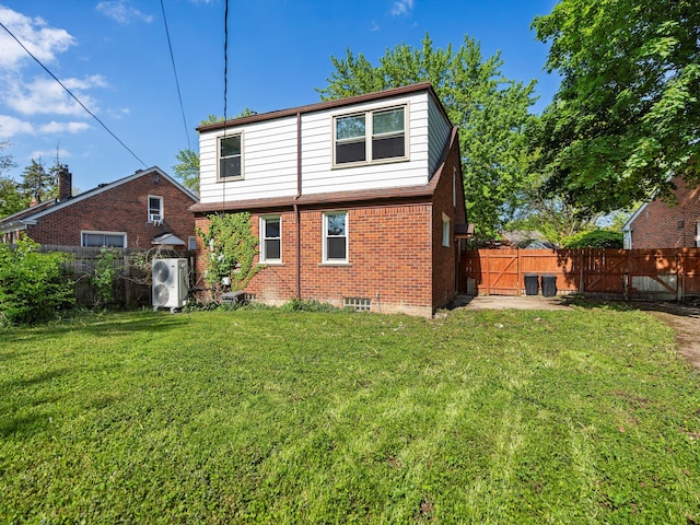 rear view of house featuring brick siding and ac unit