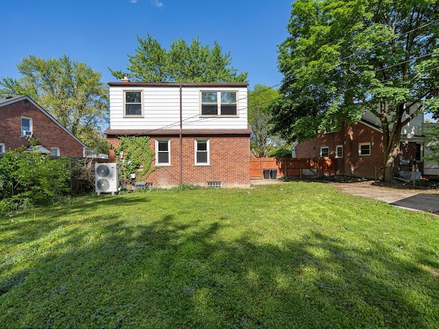 rear view of house with brick siding and ac unit