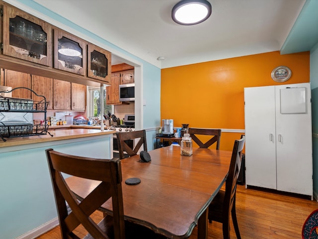 dining space featuring light wood finished floors