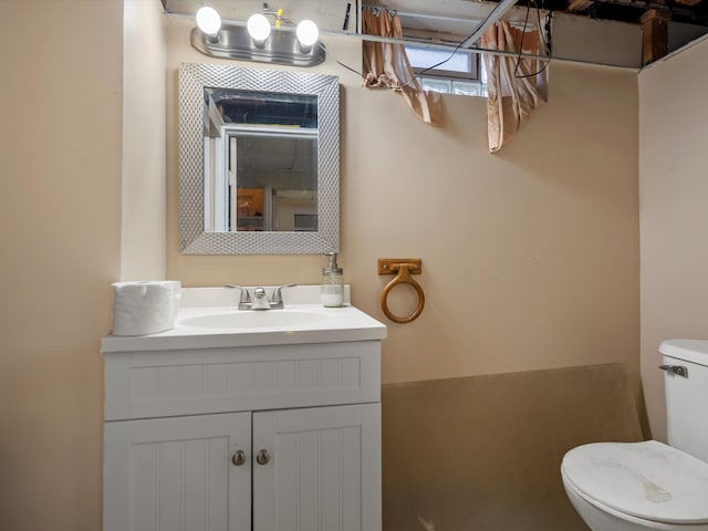 half bath featuring toilet and vanity