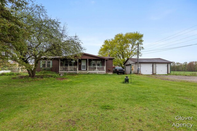 16617 W Stanton Rd, Pierson, MI 49339 - ranch-style home featuring a porch, driveway, a garage, an outbuilding, and a front lawn