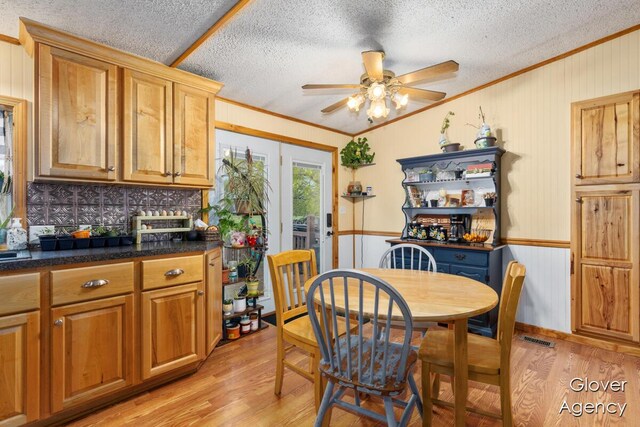 16617 W Stanton Rd, Pierson, MI 49339 - dining room with ceiling fan, ornamental molding, light wood-type flooring, and a textured ceiling