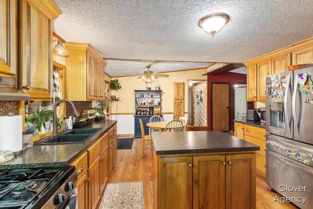 16617 W Stanton Rd, Pierson, MI 49339 - kitchen with a textured ceiling, dark countertops, stainless steel fridge, and a sink