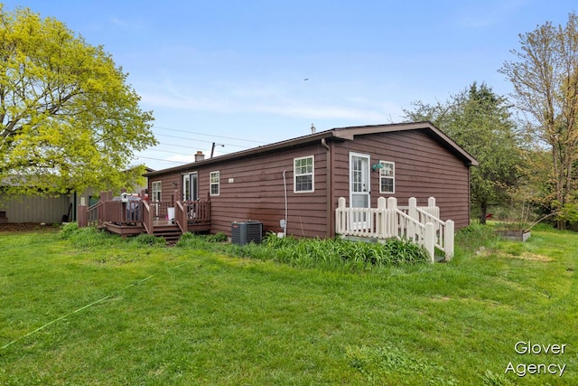 16617 W Stanton Rd, Pierson, MI 49339 - back of property featuring a yard, a wooden deck, and central AC