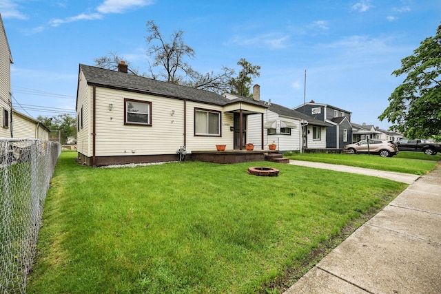 view of front of home featuring a chimney and a fire pit