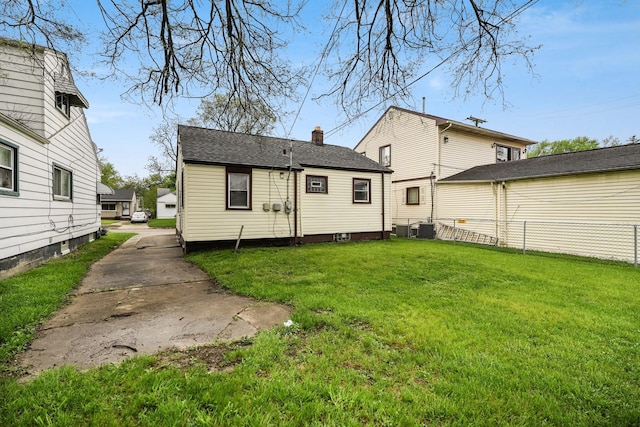 back of property with a chimney and cooling unit