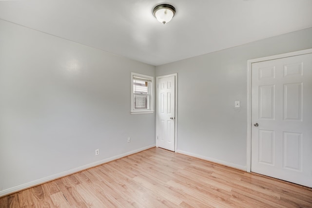 empty room featuring wood finished floors and baseboards