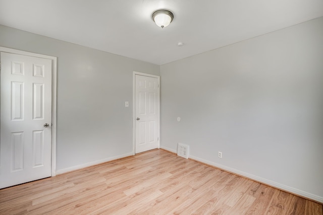 unfurnished bedroom featuring light wood-style floors and baseboards