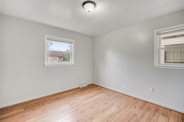 spare room with wood finished floors and baseboards