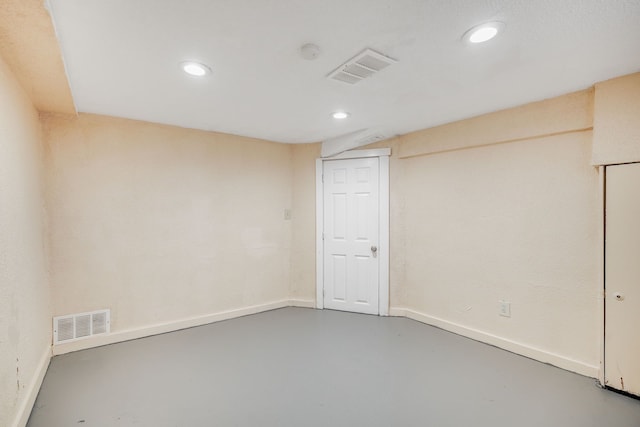 finished basement with baseboards and recessed lighting